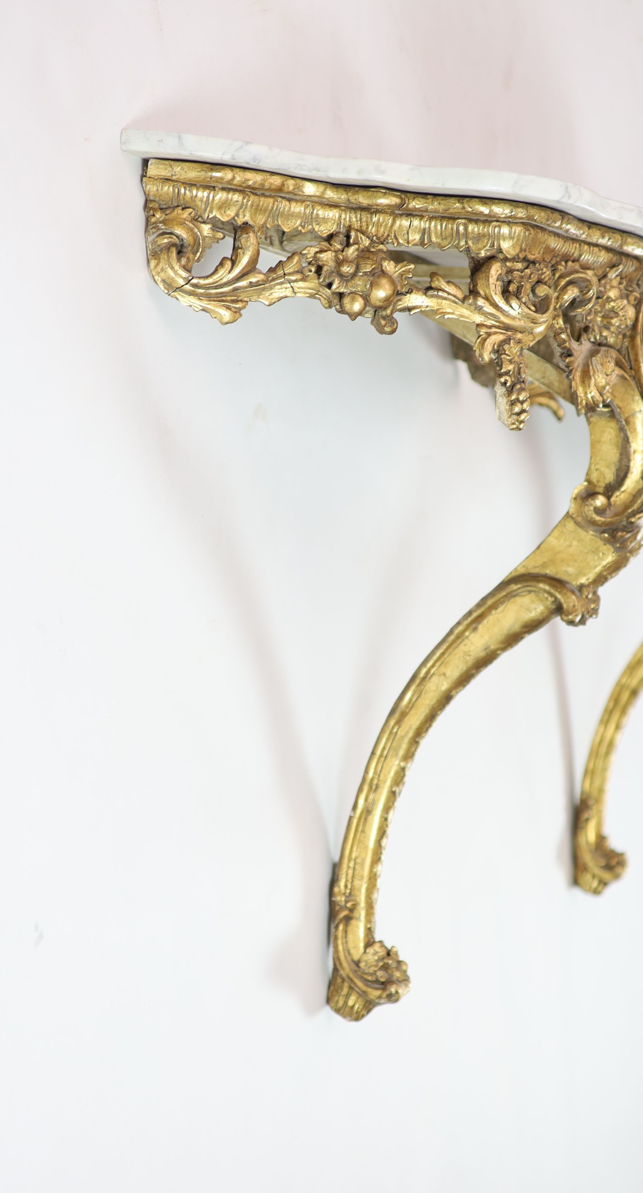 A pair of Louis XV style carved giltwood console tables H 84cm. W 98cm. D 42cm.